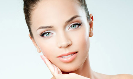 Esthetician applying a customized facial mask at Body Essentials spa in Milford